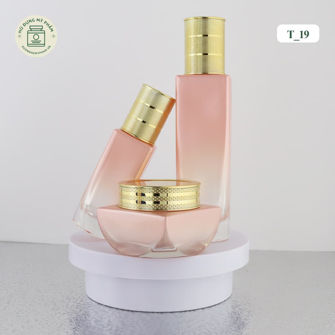 Bộ chai lọ mỹ phẩm thủy tinh màu hồng cam ombre nắp vàng kim vân lưới mã T19 sang trọng.